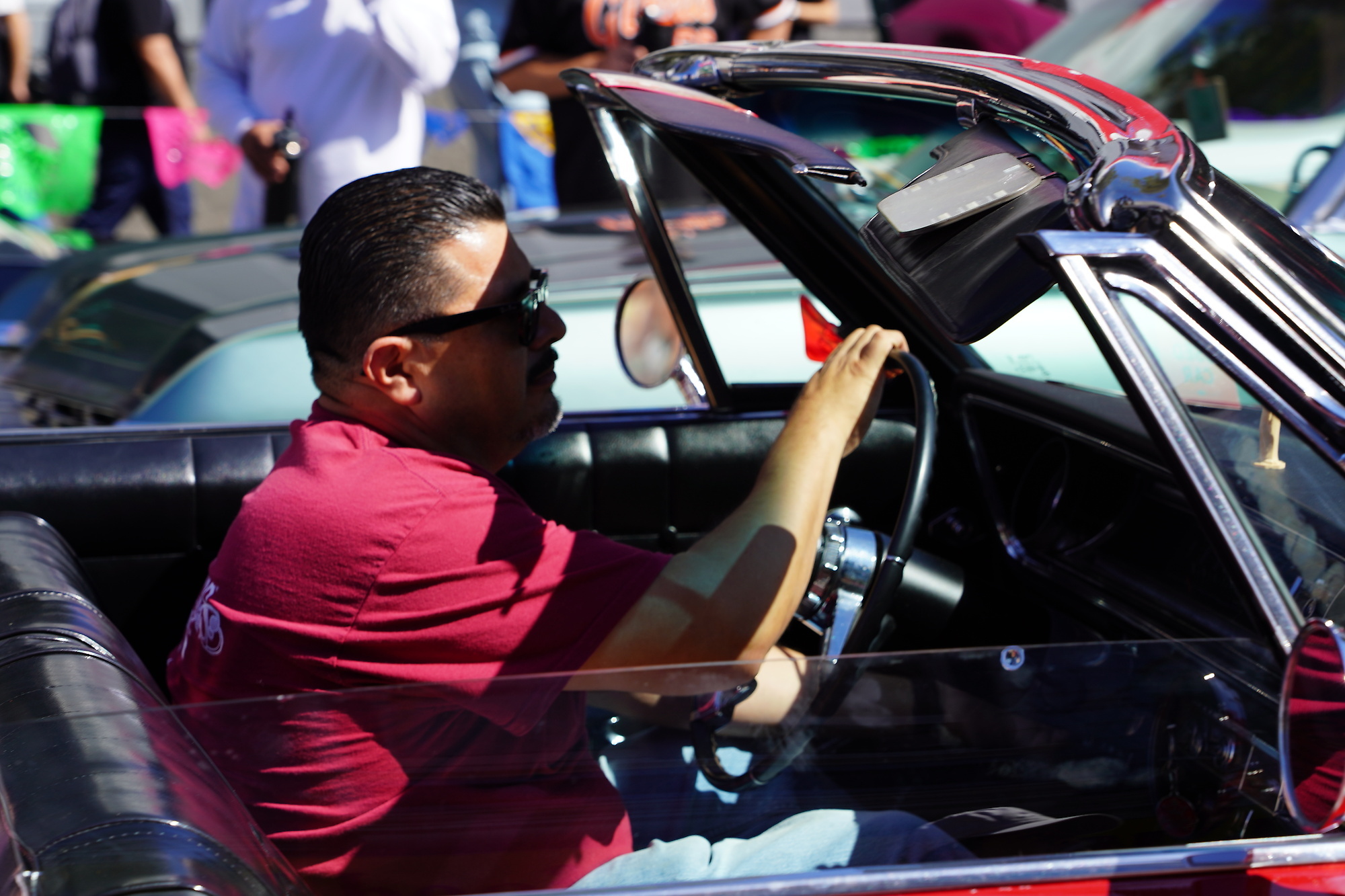 Member of the vintage car club visibly enjoys the parade drive.