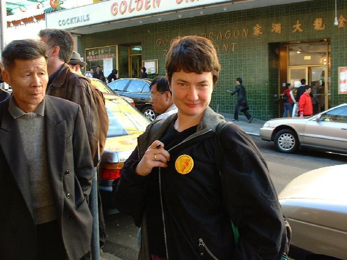 Angelika shows her tourist button. Local man, looking doubtful, suspects something terrible.